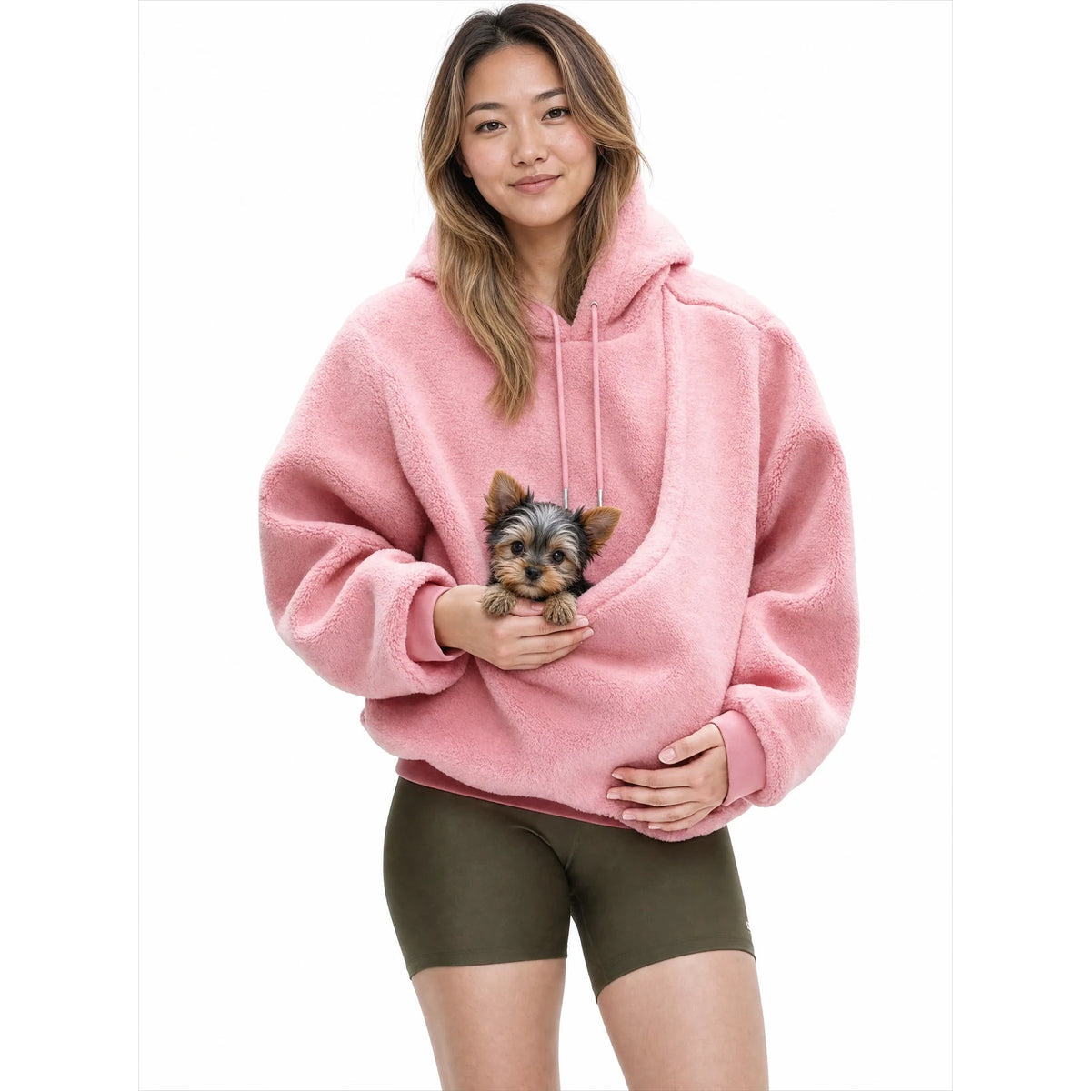 Woman wearing the pink Puppy Pouch Hoodie with a Yorkshire terrier puppy in the front carrier opening