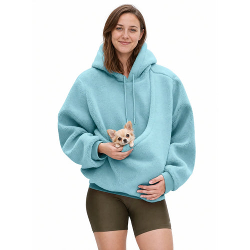 Woman wearing the sky blue Puppy Pouch Hoodie with a chihuahua puppy in the front carrier opening