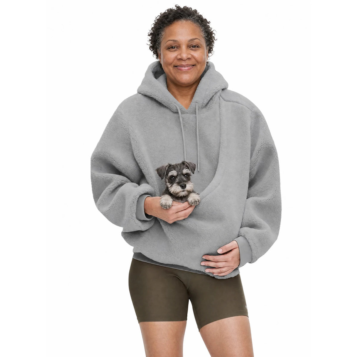 Woman wearing the grey Puppy Pouch Hoodie with a miniature schnauzer puppy in the front carrier opening