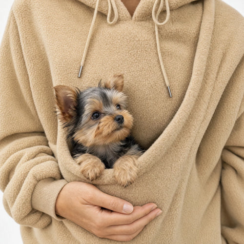 Close view of the khaki Puppy Pouch Hoodie carrier opening with a Yorkshire terrier puppy sitting inside