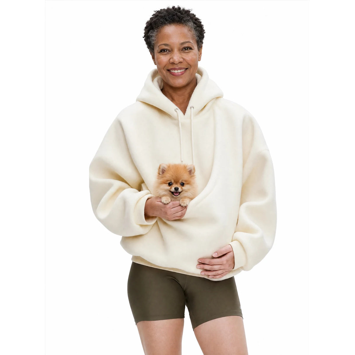 Woman wearing the creamy white Puppy Pouch Hoodie with a Pomeranian puppy in the front carrier opening