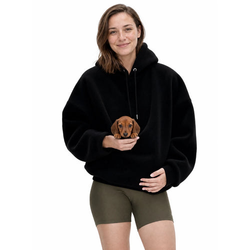 Woman wearing the black Puppy Pouch Hoodie with a dachshund puppy in the front carrier opening
