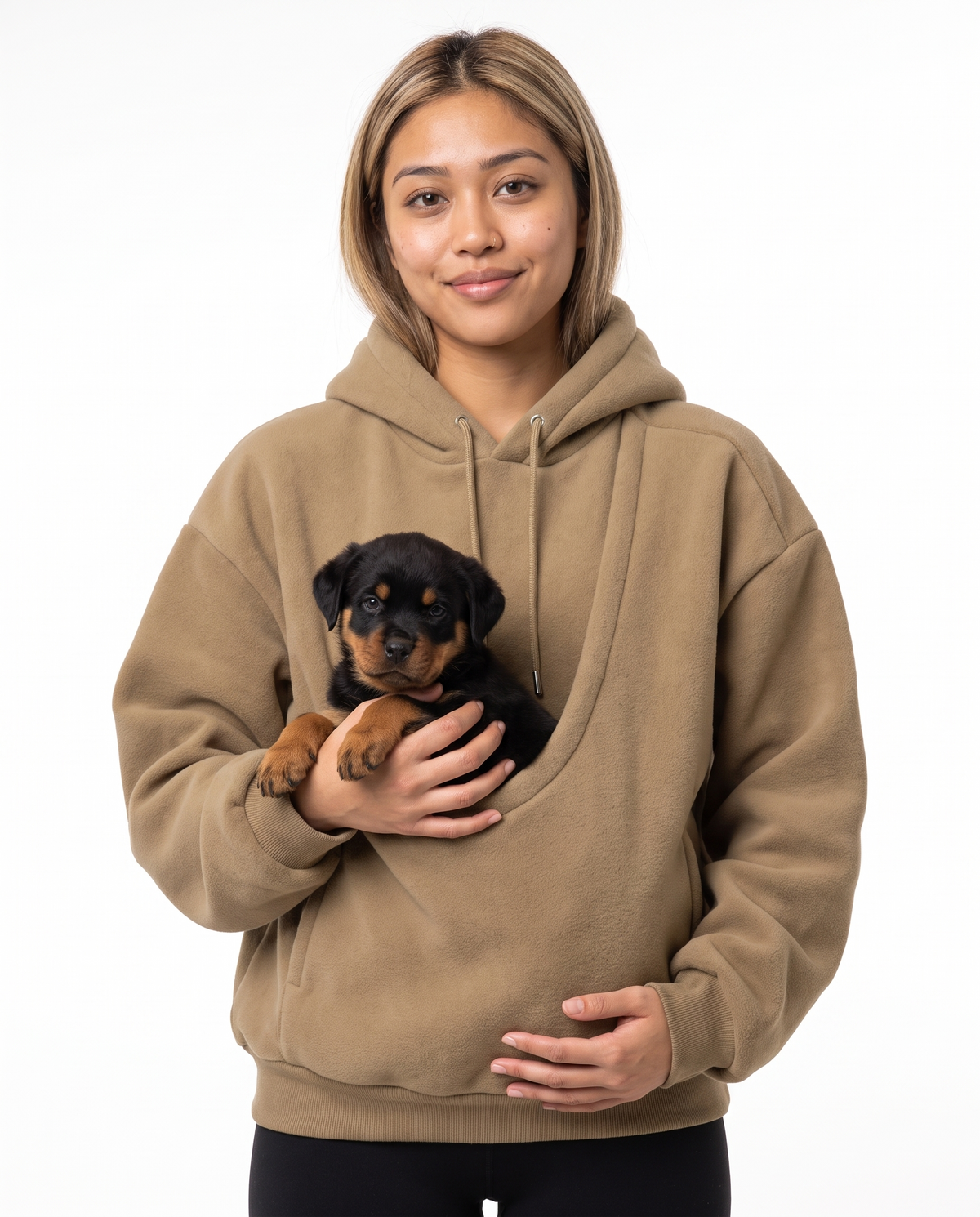 Woman wearing the khaki Puppy Pouch Hoodie with a Rottweiler puppy in the front carrier opening