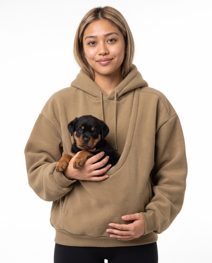 Woman wearing the khaki Puppy Pouch Hoodie with a Rottweiler puppy in the front carrier opening