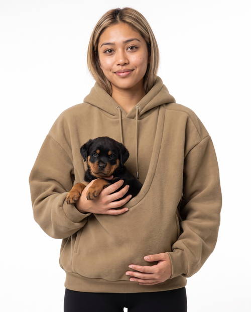 Woman wearing the khaki Puppy Pouch Hoodie with a Rottweiler puppy in the front carrier opening