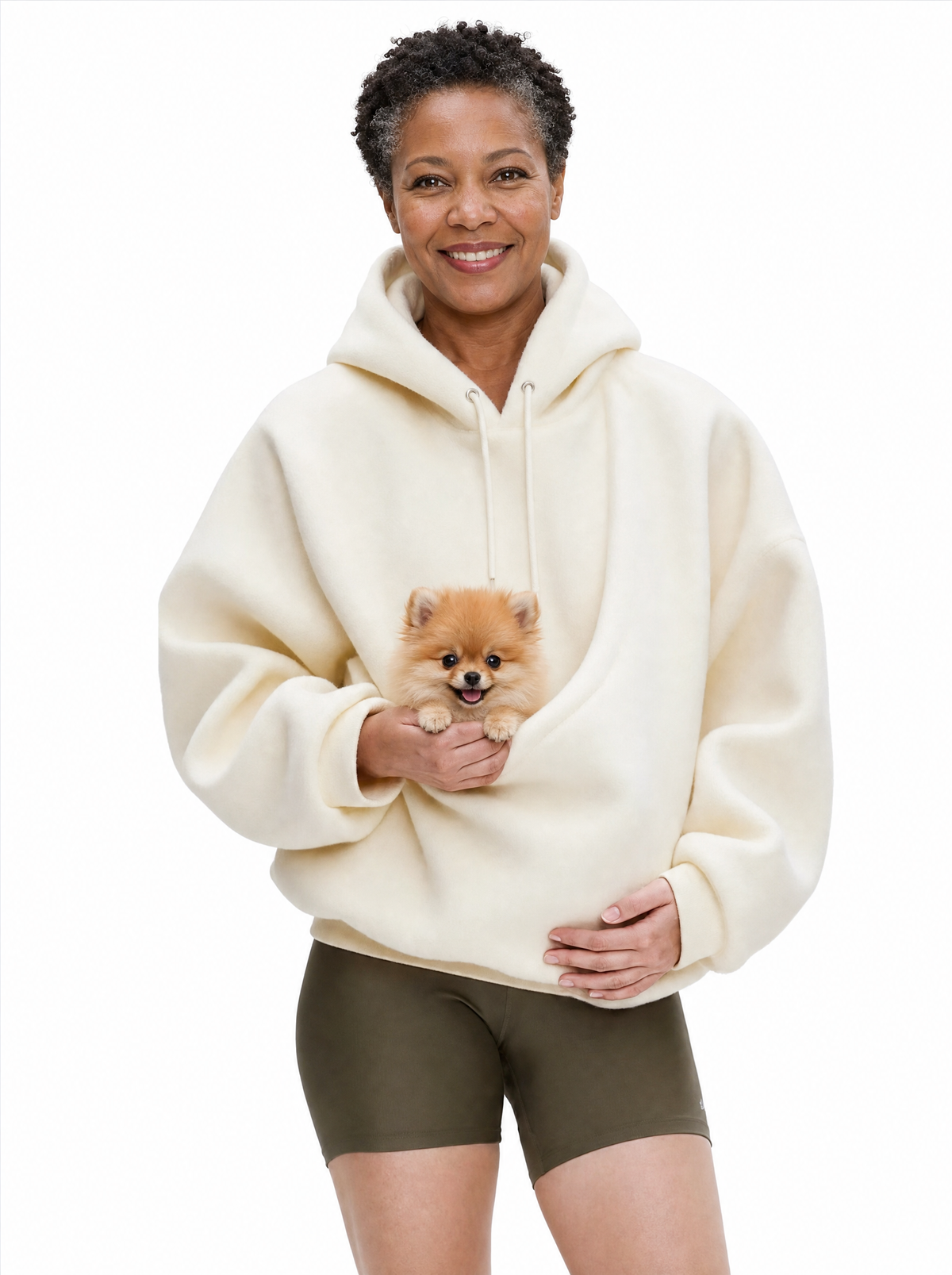 Woman wearing the creamy white Puppy Pouch Hoodie with a Pomeranian puppy in the front carrier opening