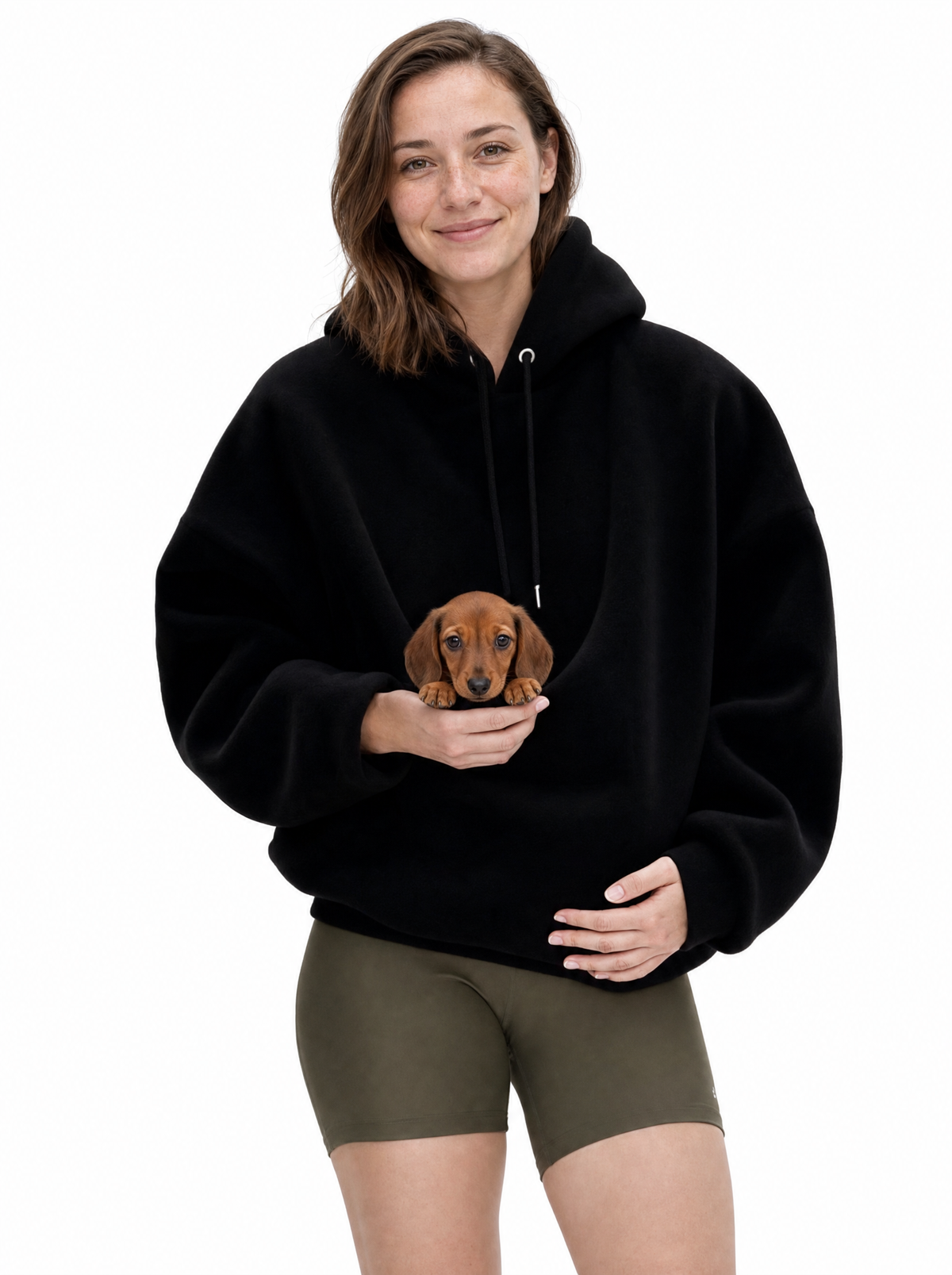 Woman wearing the black Puppy Pouch Hoodie with a dachshund puppy in the front carrier opening
