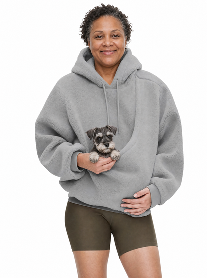 Woman wearing the grey Puppy Pouch Hoodie with a miniature schnauzer puppy in the front carrier opening